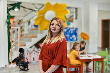 Image showing Portrait of a teacher in a preschool institution, in the background of the classrooms