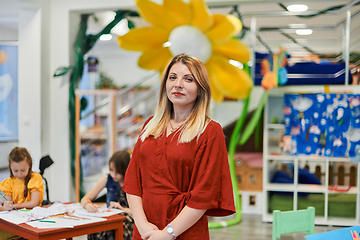 Image showing Portrait of a teacher in a preschool institution, in the background of the classrooms