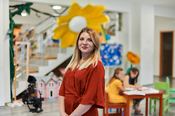 Image showing Portrait of a teacher in a preschool institution, in the background of the classrooms