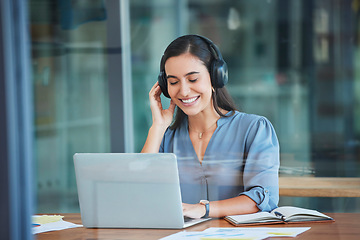 Image showing Business woman, laptop and headphones for music while working at office desk, agency or company. Happy worker listening to radio, audio or sound on computer, internet and online podcast on technology