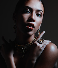 Image showing Beauty, jewelry and portrait of a woman with stylish accessories against a dark studio background. Female model with elegant, fancy and beautiful jewellery or style posing with cosmetic makeup