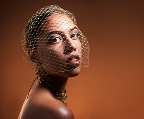 Image showing Vintage, fashionable and portrait of a woman with a net veil isolated on a brown background in studio. Fashion, stylish and face of a young retro model with a classy facial accessory on a backdrop