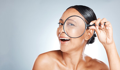 Image showing Magnifying glass, beauty and woman in a studio with a skincare, health and natural face routine. Eye, search and portrait of a mature female with wrinkles for a wellness anti aging facial treatment.