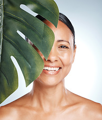 Image showing Leaf, skincare and portrait of woman in studio for skin, product and natural treatment on grey background. Plant, beauty and face of girl model smile, happy or relax for vegan, cosmetic and isolated