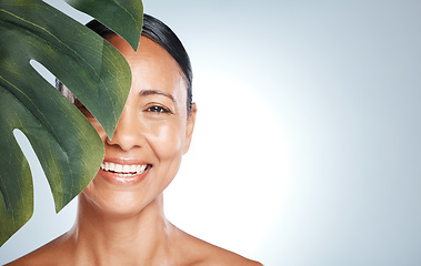 Image showing Skincare, leaf and portrait of woman in studio for skin, product and natural treatment on grey background. Plant, beauty and face of model smile, happy or relax for cosmetic and isolated on mockup