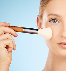 Image showing Woman, studio portrait and makeup brush for cosmetics, foundation or beauty aesthetic by blue background. Healthy model, cosmetic application and natural skin glow with self care tools by backdrop