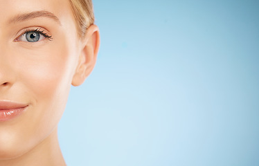 Image showing Skincare, smile and half portrait of a woman for dermatology isolated on a blue background. Makeup, wellness and face of a model for cosmetics, health and collagen with mockup space on a backdrop