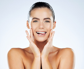 Image showing Beauty, face and skincare portrait of a woman in studio with natural glow skin and white teeth. Aesthetic model person biting on tongue for facial dermatology and spa wellness on a bright background