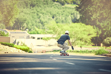 Image showing Skateboard, road and mockup with a sports man skating or training outdoor while moving at speed for action. Fitness, exercise and street with a male skater or athlete outside to practice his balance