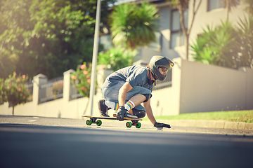 Image showing Skateboard, street and mock up with a sports man skating or training outdoor while moving at speed for action. Fitness, exercise and road with a male skater or athlete outside to practice his balance