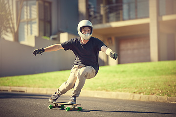 Image showing Skateboard, training or mockup with a sports man skating on a street outdoor while moving at speed for action. Fitness, exercise and road with a male skater or athlete outside to practice his balance