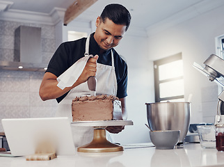 Image showing Piping, decorating and man baking a cake with chocolate in a kitchen or pastry chef happy with online recipe. Food, desert and cook preparing a sweet meal in Brazil and using a tablet