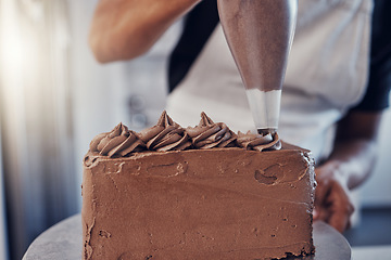 Image showing Piping, bakery and hands of baking a chocolate cake in a kitchen or pastry chef cooking a recipe. Food, dessert and cook preparing a sweet meal in Brazil and adds cream from a bag