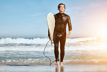 Image showing Summer, thinking and man at the beach for surfing, training and happy by the waves in Hawaii. Water, travel and surfer with a board for sports, peace and idea with flare on vacation by the ocean