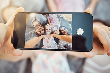 Image showing Phone screen, hands and family selfie portrait of hand with mobile zoom and smile on ground. Children, parents and happy together with love and care using a cellphone photo with kids on holiday
