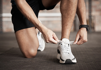 Image showing Fitness, man and shoe lace tie getting ready for running exercise, workout or training at gym. Sporty male, person or guy shoes in preparation for sport run, cardio or warm up on floor at gymnasium