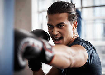 Image showing Boxer, sports and man with punching bag training for fitness, fight gym exercise or intense power challenge. Strong athlete, angry fighter or person boxing for health performance, cardio or workout