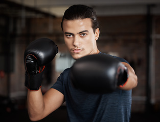 Image showing Portrait, fitness and workout with a boxer man training for a fight or competition in a gym for sports. Health, exercise and power with a young male athlete boxing in an mma or self defense club