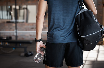 Image showing Exercise, bag and back of man in gym ready to start workout. Sports, fitness and hands of male athlete with water bottle for hydration and preparing for training and exercising for health or wellness