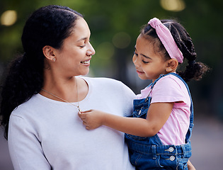 Image showing Family, mother and carrying little girl with smile for outdoor bonding and hugging at a park. Motherhood support, care and love with daughter, child or kid touching necklace or jewelry on mom outside