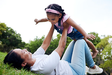 Image showing Black family, park and flying with a woman and girl having fun together while bonding on grass outdoor. Kids, love and nature with a mother and daughter playing in a green garden outside in summer