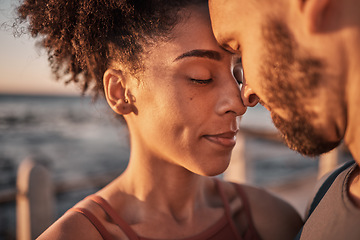 Image showing Black couple, hug and touching forehead embracing relationship, compassion or love and care by the beach. Happy man and woman with heads together smiling in happiness for support, trust or romance