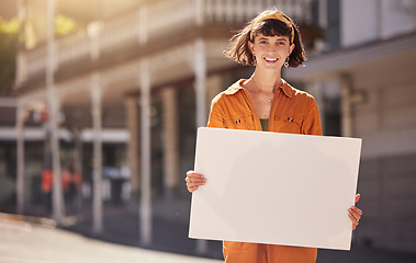 Image showing Woman, lgbt and board poster in city, smile and portrait for human rights, non binary and opinion. Gen z activist girl, pride march, parade and outdoor in urban metro for lgbtq, equality and peace