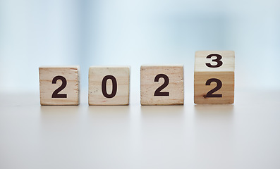 Image showing Calendar, 2023 countdown and wooden blocks on empty table in grey studio background for goals or resolution. New year, celebrate and start for corporate growth or new change motivation with toy block