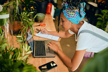 Image showing Laptop, small business or black woman writing a checklist on plants or flowers for commerce or stock inventory. Management, store manager or entrepreneur planning or working on floral growth research