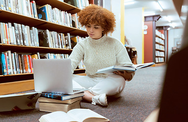 Image showing Student learning, laptop research and black woman in library working on the floor with books. Reading, computer research and online study of a person with test and exam information for university