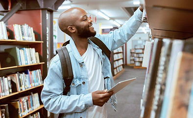 Image showing Black man, student and library bookshelf of a university, college and knowledge center. Notebook, happy young person and smile of a male with books for learning and study research info at school