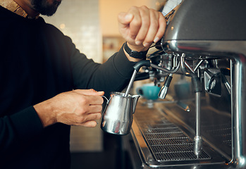 Image showing Hands, man and barista brewing at coffee shop using machine for hot beverage, caffeine or steam. Hand of employee male steaming milk in metal jug for premium grade drink or self service at cafe