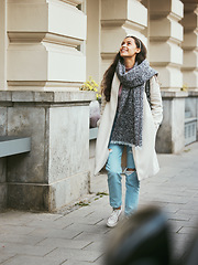 Image showing Woman, walking or sightseeing city buildings in road, street or New York in morning commute, travel or holiday vacation. Smile, happy person and fashion tourist in warm and cool clothes on sidewalk