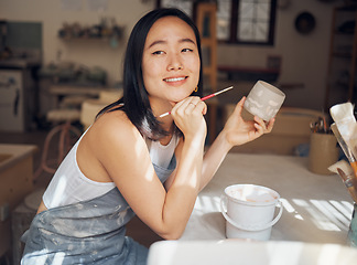 Image showing Woman, potter or thinking of product design ideas, cup painting vision or creative color in Asian pottery studio. Smile, happy or clay store worker and mug goals, small business or ceramic workshop