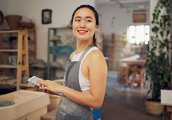 Image showing Tablet, small business and woman in pottery workshop for ceramic startup, research and online website. Creative art, ecommerce and asian lady with tech to sell clay, sculpture and handmade products