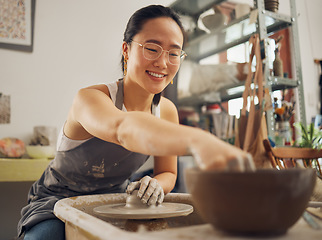 Image showing Happy, pottery or woman in designer workshop working on cup sculpture or mug mold in small business. Smile, artistic girl or creative Japanese worker busy with handicraft products as entrepreneur