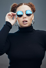 Image showing Fashion, beauty and face of woman with sunglasses in studio for cosmetics, makeup and luxury style. Magazine model, designer brand and confident girl with accessories, trendy clothes and jewellery