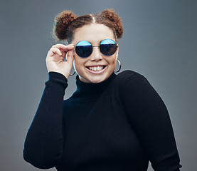 Image showing Fashion, smile and woman with sunglasses for beauty cosmetics, makeup and luxury style in studio. Aesthetic, designer brand and confident girl with stylish accessories, trendy and edgy jewellery