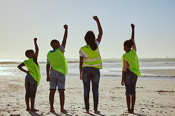 Image showing Teamwork, recycle and hands of volunteer at the beach for cleaning, recycling and earth day. Community, charity and support with fist of people for environment, eco friendly and sustainability change