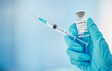 Image showing Doctor, hands and syringe with covid vaccine for cure, healthcare or medical medication to combat virus. Hand of nurse holding corona virus sample with needle for vaccination from illness or disease