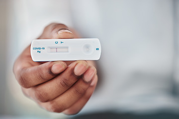Image showing Rapid exam and black man hand with covid test for quick viral detection and healthcare check. Corona virus pcr and results of person with medical kit at hospital or virus testing clinic zoom.