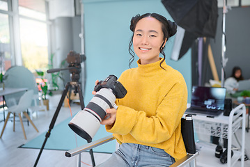 Image showing Happy, photoshoot and portrait of a photographer with a camera for production, video and media. Creative, smile and an Asian woman in a studio for filming, shooting and working in photography