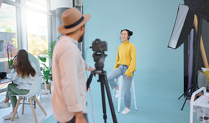 Image showing Photographer, shoot and woman model in studio for professional, photo and posing on wall background. Photography, magazine and man taking pictures of asian girl on mockup, creative and contemporary