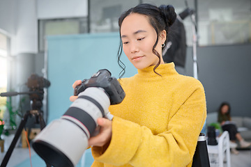 Image showing Photography camera, asian woman and digital agency worker review pictures in a studio. Photographer, production process and professional photoshoot with a creative employee checking catalog results