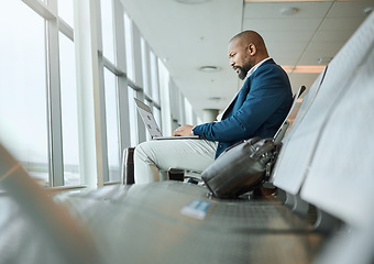 Image showing Travel, vip and businessman on a laptop at an airport working and waiting at terminal or boarding lounge. Entrepreneur, corporate or professional using computer at airline hub about to go on a flight