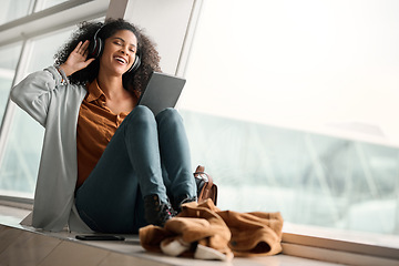 Image showing Relax, travel or black woman on tablet and headphones for music, podcast or radio in airport lobby. Smile, mockup or happy girl on audio tech for communication, networking or social media network app