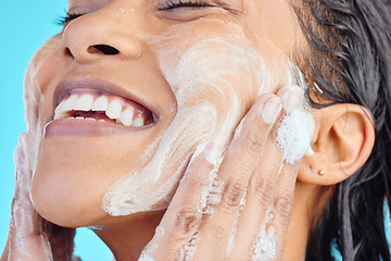 Image showing Shower soap, happy face and black woman cleaning body with liquid for hydration, beauty healthcare or skincare hygiene. Self care studio, spa foam and relax model washing isolated on blue background