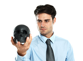 Image showing Businessman, black skull in hand in studio for death, symbol and failure on white background. Mental health, man and skeleton head for hypnosis, emoji and bad luck, horror and end while isolated