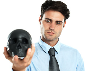 Image showing Hand, black and skull by businessman in studio for death, symbol and failure against white background. Horror, fail and man showing human head for manipulation, emoji and bad luck while isolated