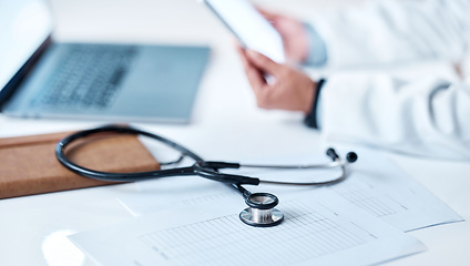 Image showing Stethoscope, desk and documents with hands, tablet or research for doctor in hospital office. Healthcare clinic workspace, telehealth communication or tools for paperwork, notebook or laptop on table